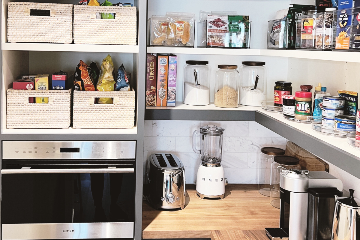 Organized pantry in a Newport Beach home with baskets, containers, and everyday kitchen essentials arranged for easy access.