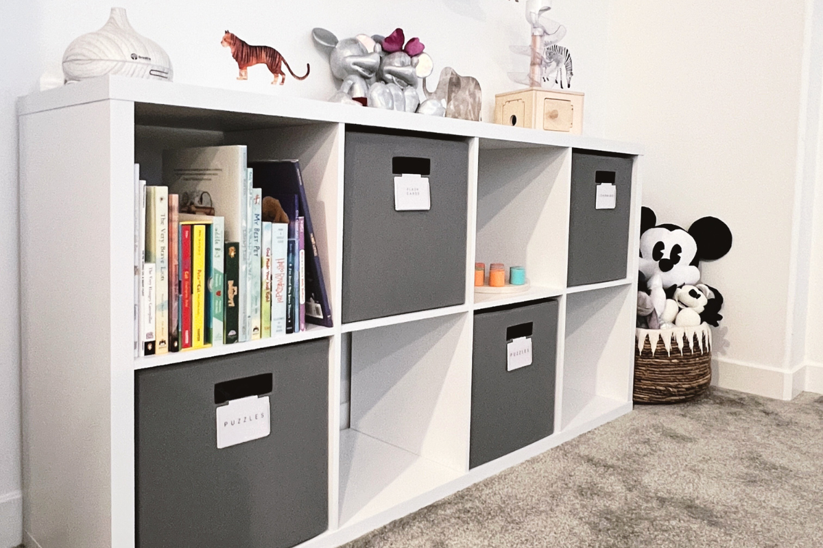 Organized playroom in a Brentwood home with defined storage for toys and books designed to make everyday cleanup easier.