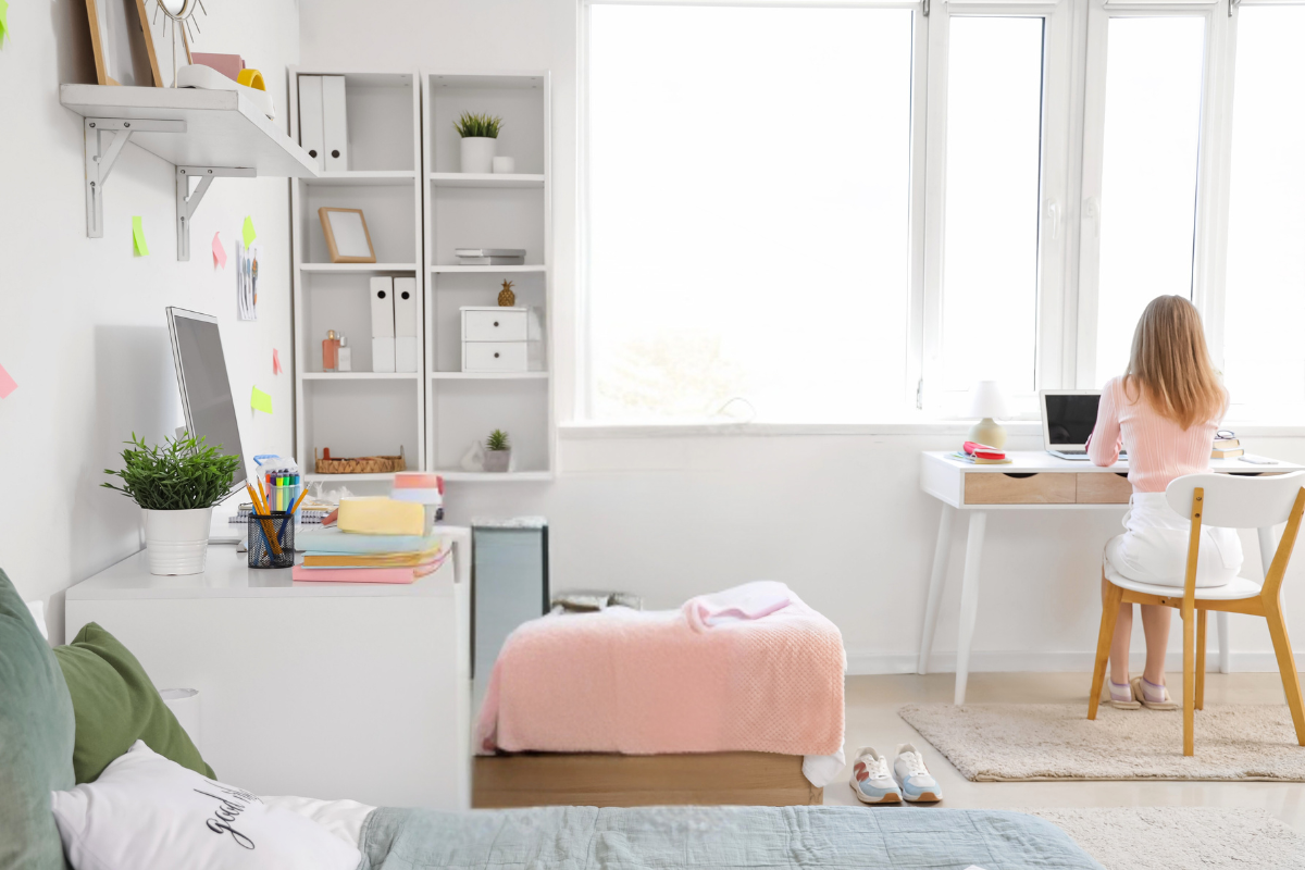 Organized college dorm room with a study desk, storage, and everyday essentials arranged for student routines.