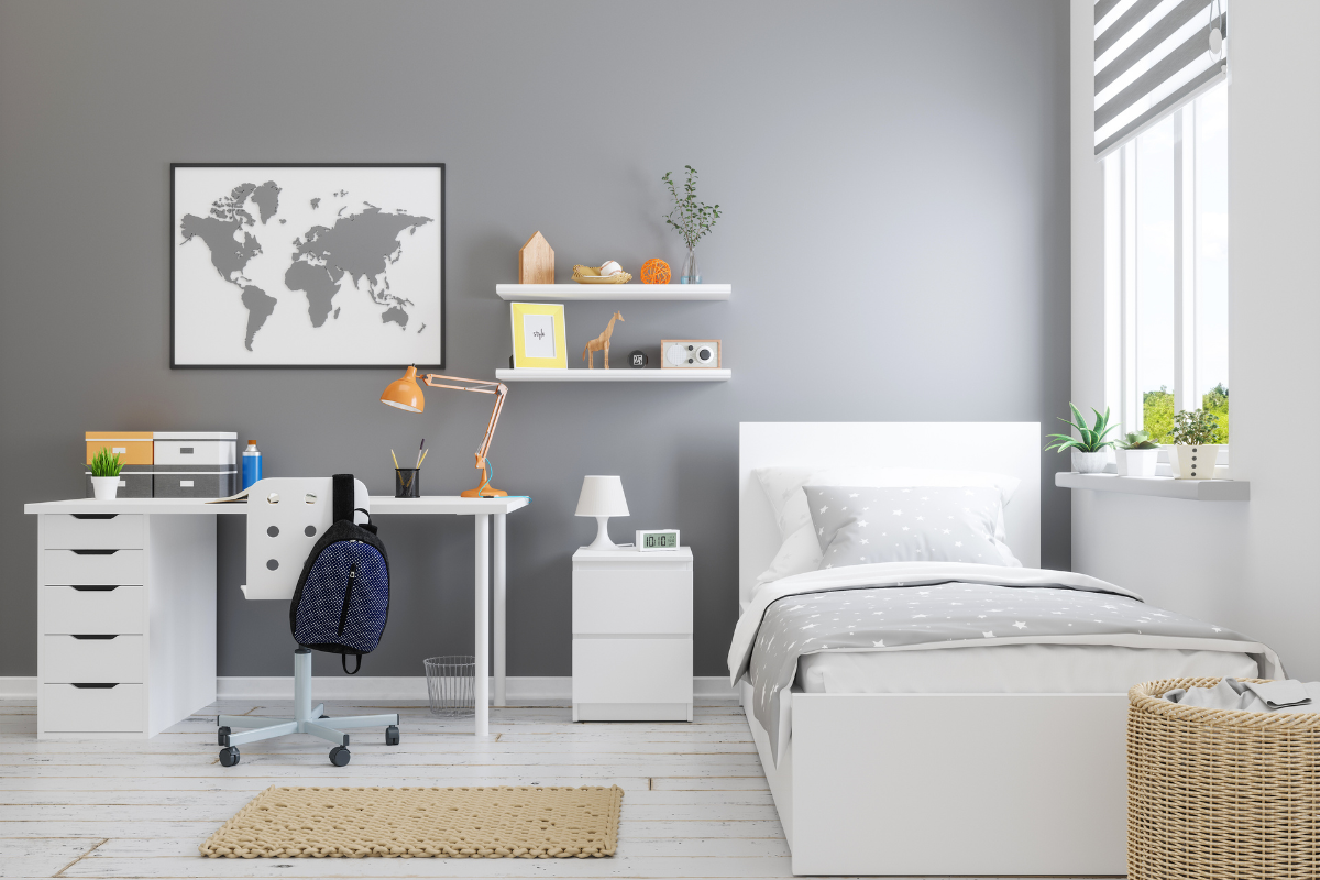 Organized study area in a child’s bedroom with a desk, shelving, and storage designed to keep schoolwork within easy reach.