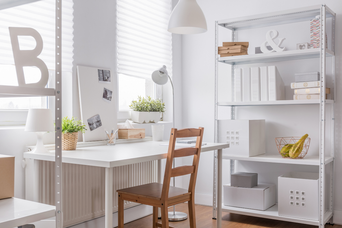 Organized kids’ study room with a white desk, shelving, and accessible storage for school supplies.
