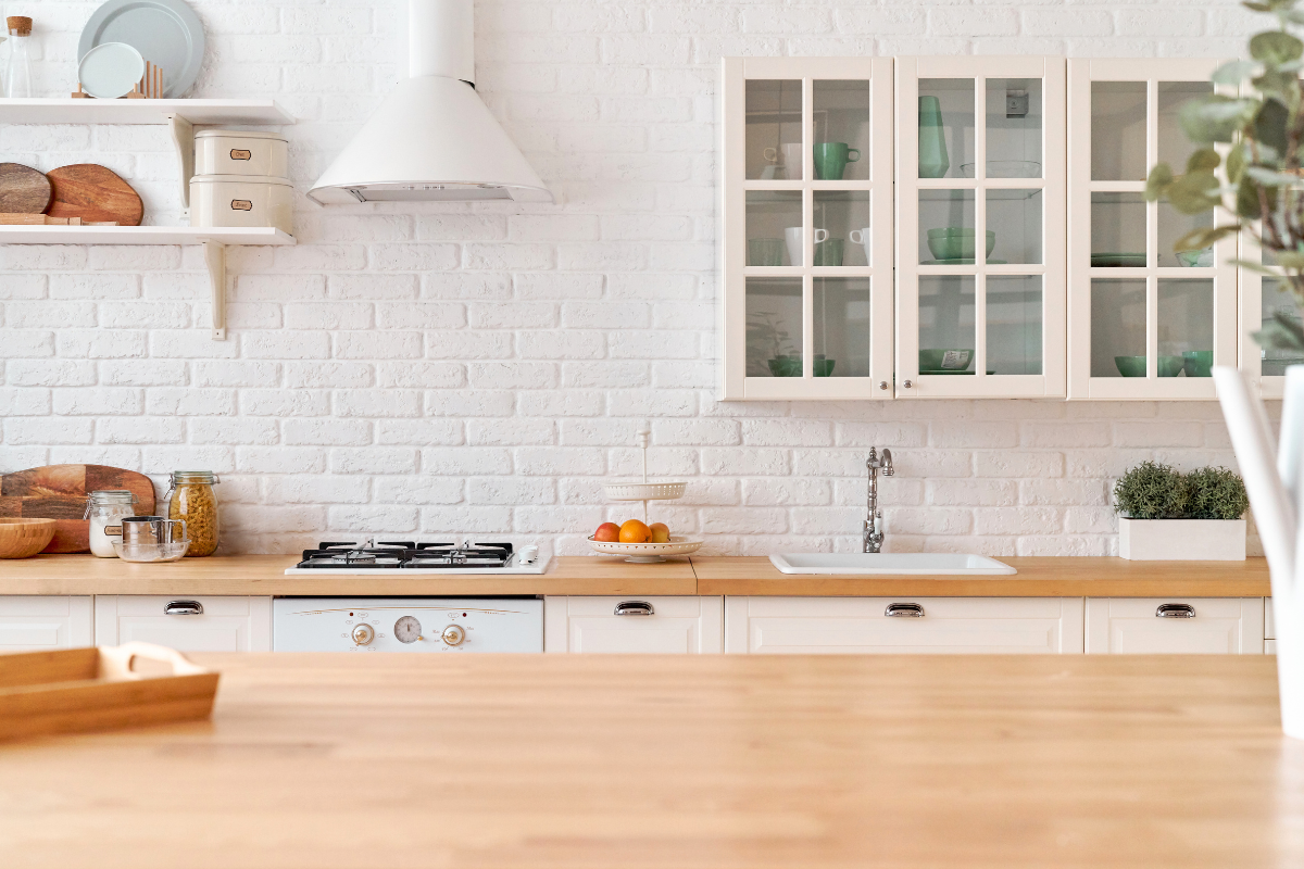 Organized white kitchen with open shelving and everyday items arranged for easy use and visibility.