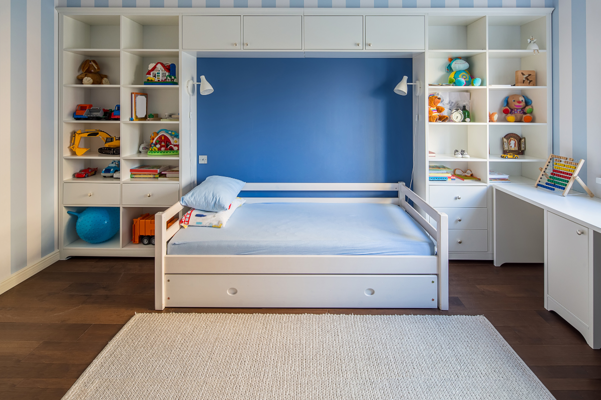 Organized children’s bedroom with toys stored on accessible shelving to support independent play and easy cleanup.