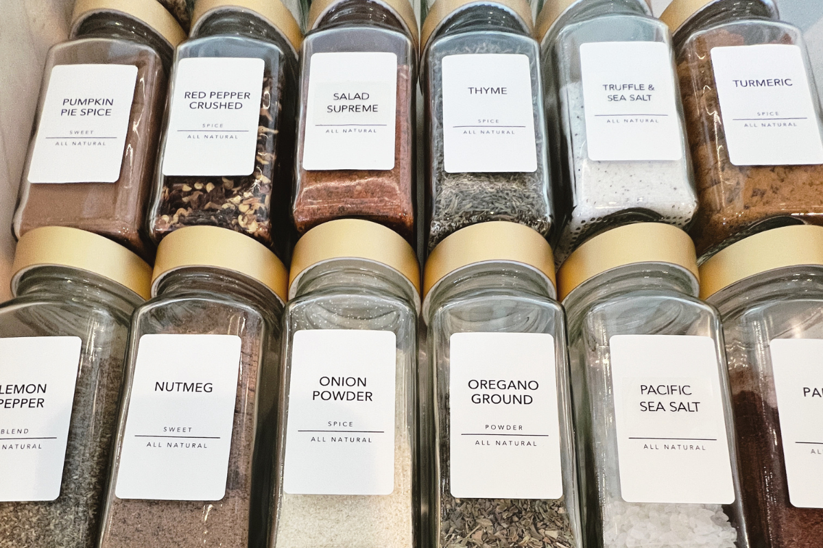 Organized spice drawer with seasonings arranged for clear visibility and easy access while cooking.