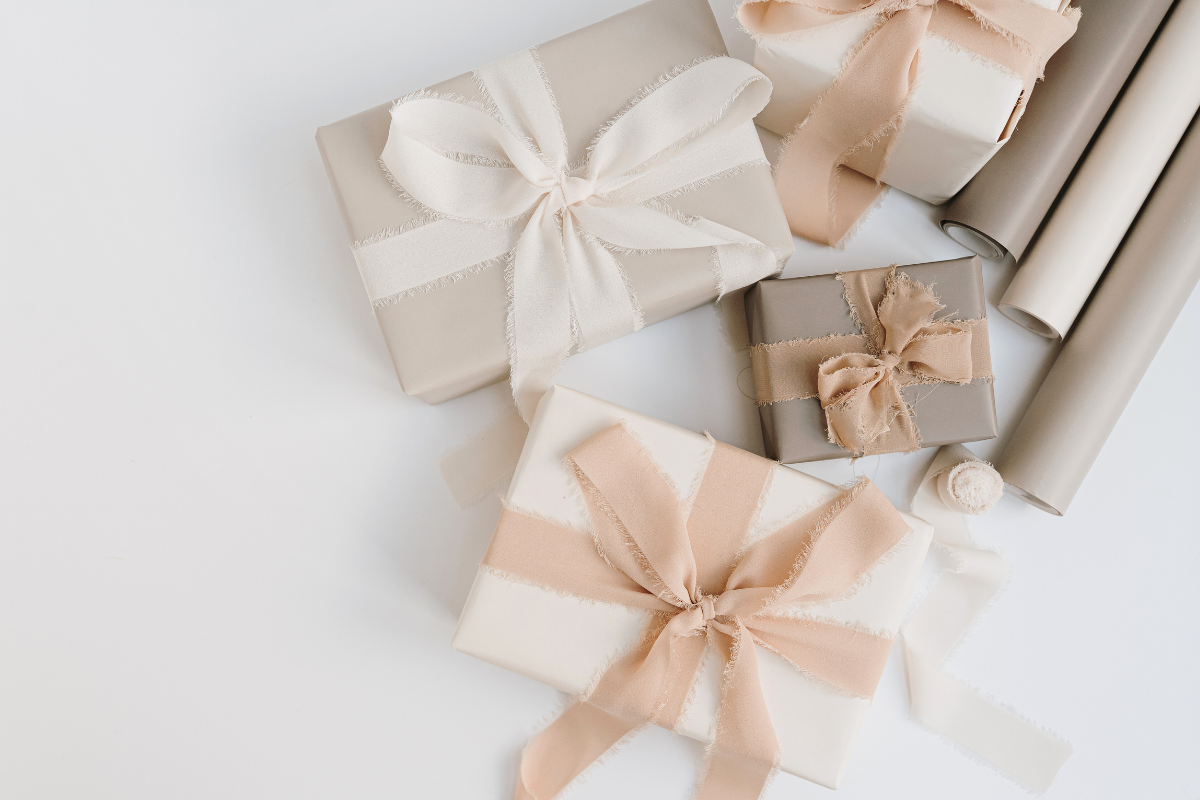 Wrapped gifts with coordinated paper and ribbon, illustrating an organized approach to gift wrapping.