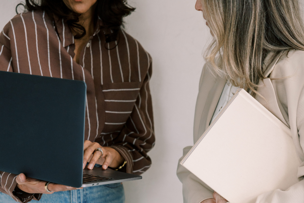 Two women reviewing move planning details together during a relocation consultation.

